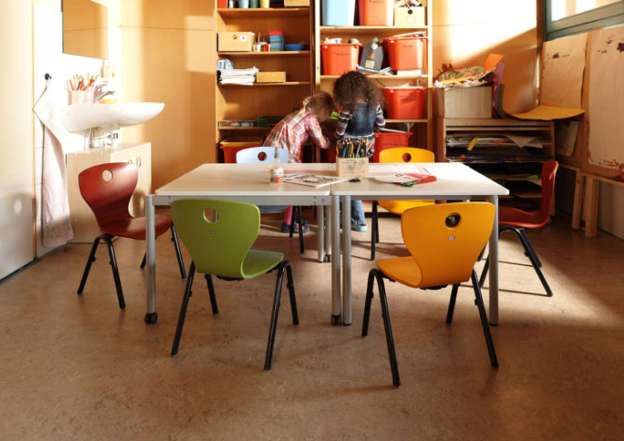 Robust, stackable chair with wooden seat shell.